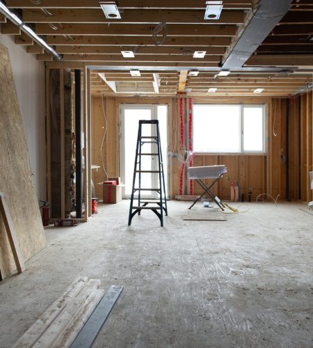 Renovation at residential house in Toronto, Ontario. Tools and wood supply are present on the floor. Steel beams and lighting plates are visible.